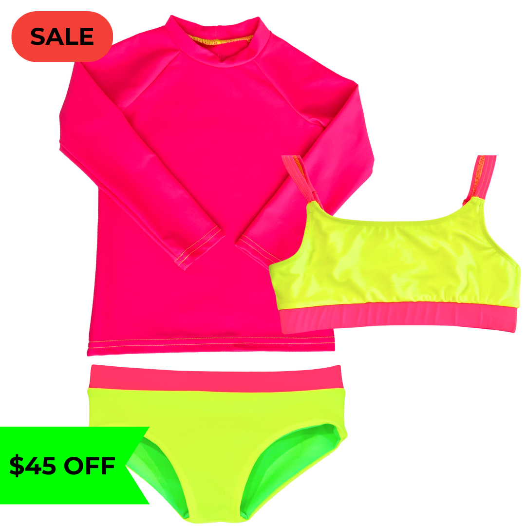 Bright neon pink UPF long sleeved sun shirt rash guard paired with a girls' swimsuit featuring neon yellow and neon pink accents, along with reversible bikini bottoms in neon yellow and neon green. This hi vis swimsuit is designed for high visibility, allowing the swimmer to stand out from any background.